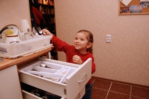 Abby's job is to put away the silverware.