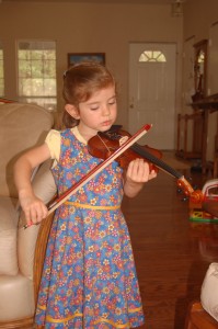 Abby practices her violin.