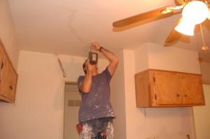 Anthony Courter repairs drywall in our kitchen.