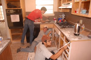 Painting the kitchen cabinets. From the top: Aaron Courter, Jeremy Steele, Steven Nguyen