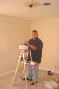 Alex installs a new ceiling fan.