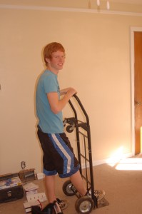 My brother Josiah poses for this shot with the, uh, appliance dolly. That came in handy later when we rolled in the new refrigerator that was given to us by the Gerhart family.